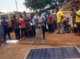 Participants at a demonstration with solar energy panels