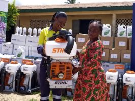 Mrs Kuutor (left) presenting a mist blower machine to Cecilia Gyimah from Bompieso