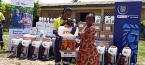 Mrs Kuutor (left) presenting a mist blower machine to Cecilia Gyimah from Bompieso