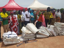 The team from Guinness Ghana handing over the tarpaulins