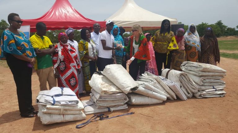 The team from Guinness Ghana handing over the tarpaulins