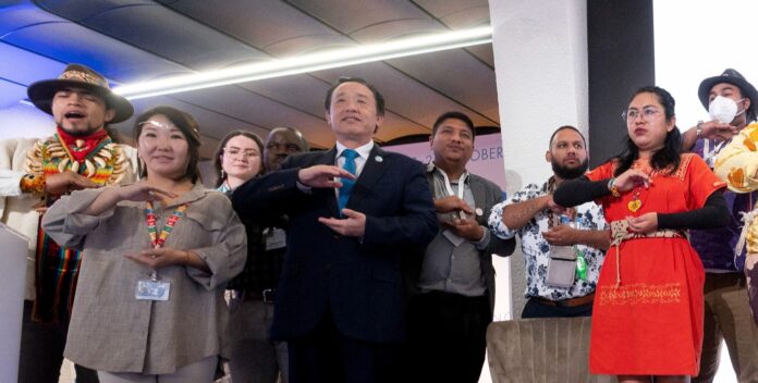 FAO Director-General QU Dongyu with indigenous youth advocates who have been a key part of the activities at the WFF ©FAO/VIctor Sokolowicz