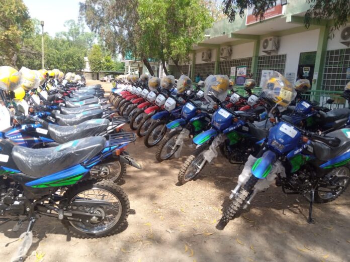 Mrs Paulina Rozycka of the EU, handing over the motorbikes to Alhaji Mohammed Hardi Tufeirua, Deputy Minister of Agricul