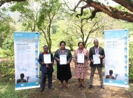 Officials and tilapia value chain players pose for a photo with the signed Mutare declaration at the launch of the strategy
