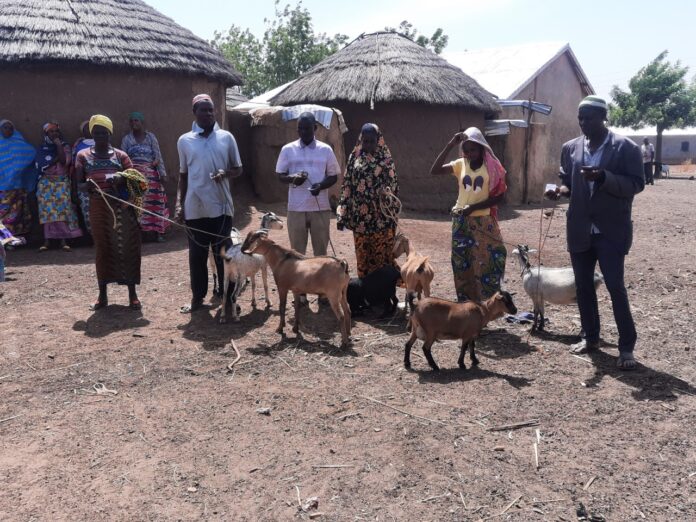 Some of the beneficiaries with their goats Some of the beneficiaries with their goats