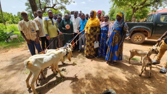 Sissala East MCE, Mr. Fuseini Batong Yakubu hands over goats to beneficiaries at Tumu