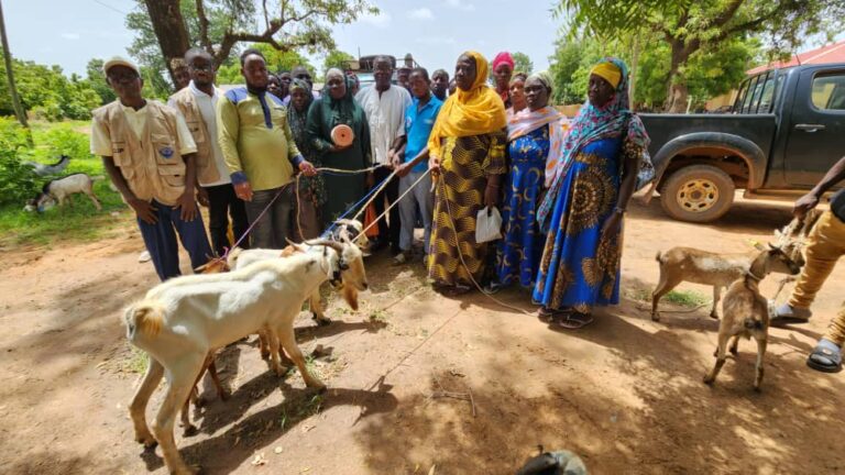 Sissala East MCE, Mr. Fuseini Batong Yakubu hands over goats to beneficiaries at Tumu
