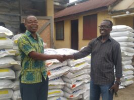 Economy Feed Distribution – Mr. Francis Barnes Director of the Eastern Regional Fisheries Commission shaking hands with the CEO, Kosaach Farms.