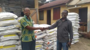 Economy Feed Distribution – Mr. Francis Barnes Director of the Eastern Regional Fisheries Commission shaking hands with the CEO, Kosaach Farms.