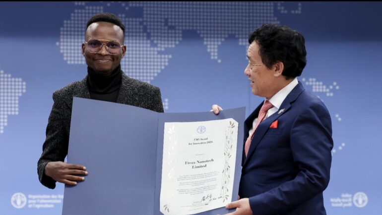 FAO Director-General QU Dongyu presents the FAO Innovation Award to Mugisha Gift Arnold of Freza Nanotech Limited ©FAO/Alessandra Benedetti