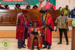 Professor Ansah delivering the address, with some participants 