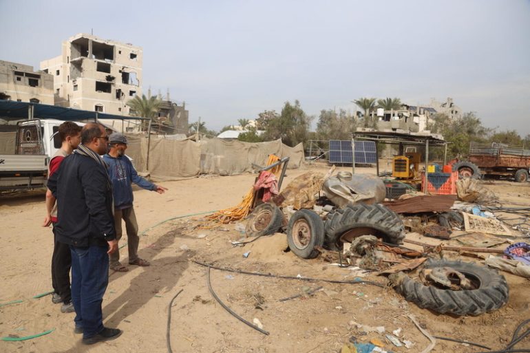 FAO staff look on as they assess damages to agricultural equipment, Khan Younis, Gaza Strip. ©FAO/Yousef Alrozzi