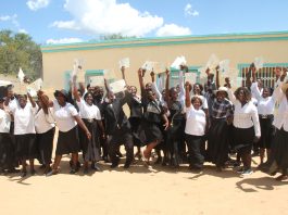 Celebrating success! Farmers proudly display their certificates after completing the Farmer Field School programme ©FAO/Kevin Mazorodze