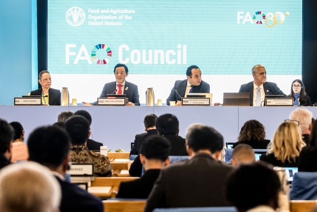 FAO Director-General QU Dongyu, second from left, addresses the 180th Session of FAO Council next to Mina Rizk, Independent Council Chairperson, center. ©FAO/Alessandra Benedetti