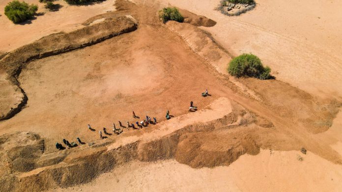Aerial view of community members taking part in FAO's cash-for-work initiative to rehabilitate a communal water catchment, strengthening local water access and resilience in Galka’ayo, Galmudug State, Somalia. ©FAO / Arete/Ali Adan