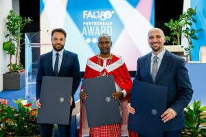 (L–R) Jonas Stumpf, Managing Director of Help Logistics; Philip Koyei, Maasai Integrated Development Initiative (MIDI) and Ali Haddad, Executive Director of the Jordan Youth Innovation Forum, winners of the FAO Partnership Award, pose for a group photo at FAO's headquarters in Rome.©FAO/Giuseppe Carotenuto