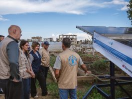 FAO Deputy Director-General Beth Bechdol (3 L), Assistant Director-General and Regional Reprsentative for the Near East and North Africa, AbdulHakim Elwaer (4 L), Director of Emergencies Rein Paulsen (L), FAO Representative in Lebanon Veronica Quattrola (2 L) stand next to the solar array during a field visit in Lebanon to meet a group of farmers who are using an innovative shared solar-powered irrigation pump to irrigate their greenhouses. ©FAO/ Ralph Azar
